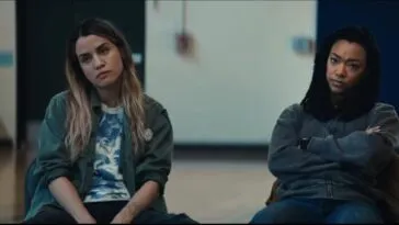 Two women sitting next to each other in a large auditorium in MY DEAD FRIEND ZOE