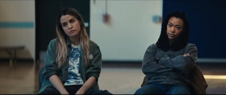 Two women sitting next to each other in a large auditorium in MY DEAD FRIEND ZOE