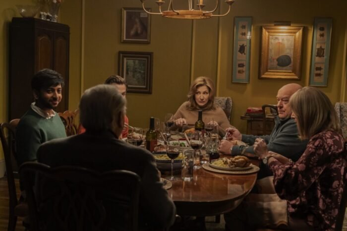 A group of people eating dinner at a dining room table.