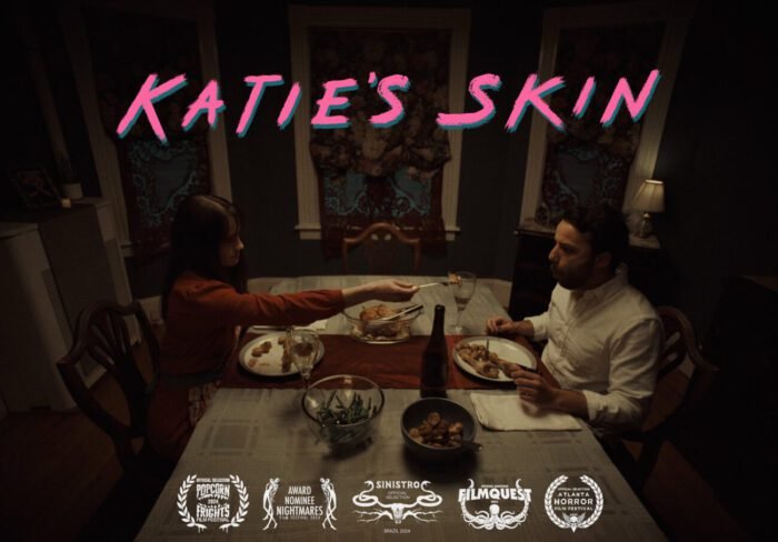 A couple is sitting at a dinner table while the title KATIE'S SKIN stretches over the top part of the image and the festivals it has played are displayed on the bottom.