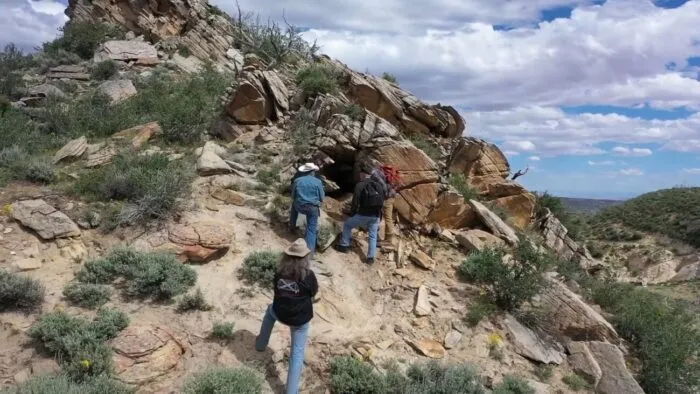 Duane Ollinger stands back and watches as Chad Ollinger pulls ingot slags out of the earth