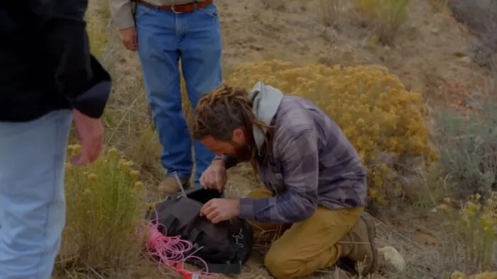 Chad digs through one of the poacher's bags