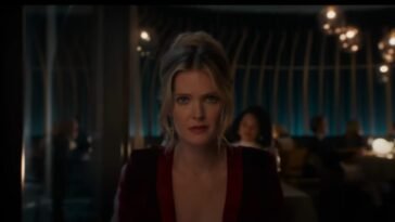 A woman in a red dress sitting in a restaurant