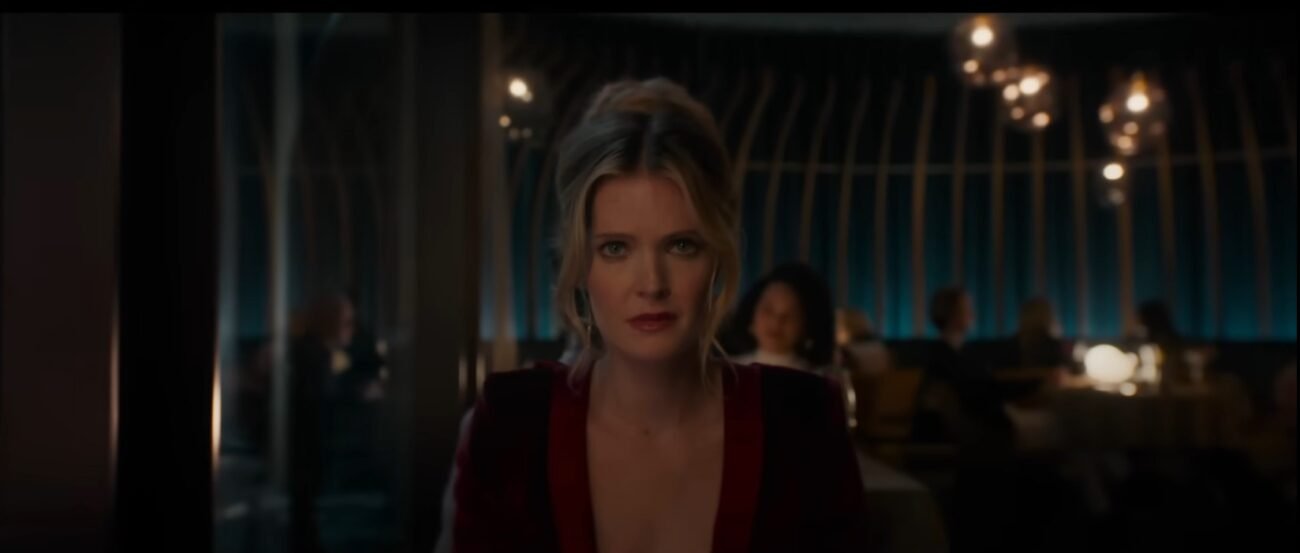 A woman in a red dress sitting in a restaurant