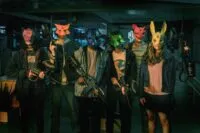 A group of teenagers in masks stand beside one another