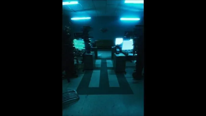 Out of focus people standing around out of focused computers in an office setting in PROJECT MKHEXE