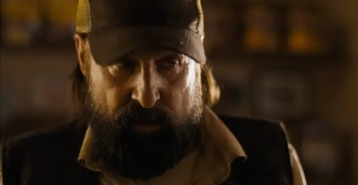 a rugged looking man in a baseball cap