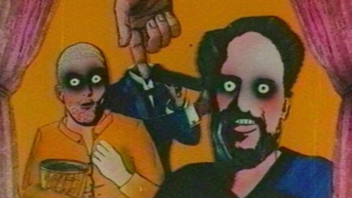 An animated lobby program shows two men with sunken eyes and a third having his head tucked into his suit by an ominous hand