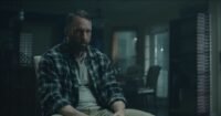 A man sits in a chair.