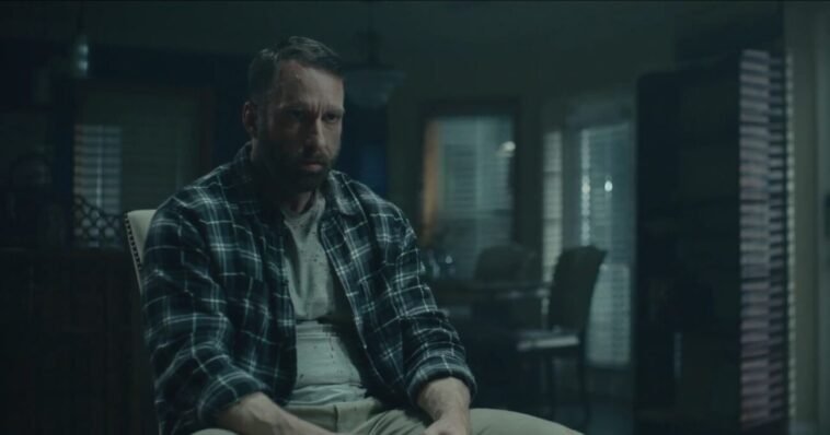 A man sits in a chair.