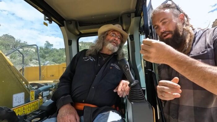 Chad shows Duane the black rocks found in the ground