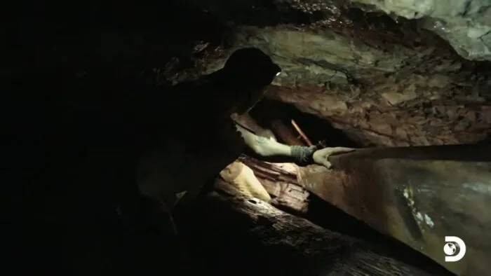 Ryan assesses the logs in the Great Cavern