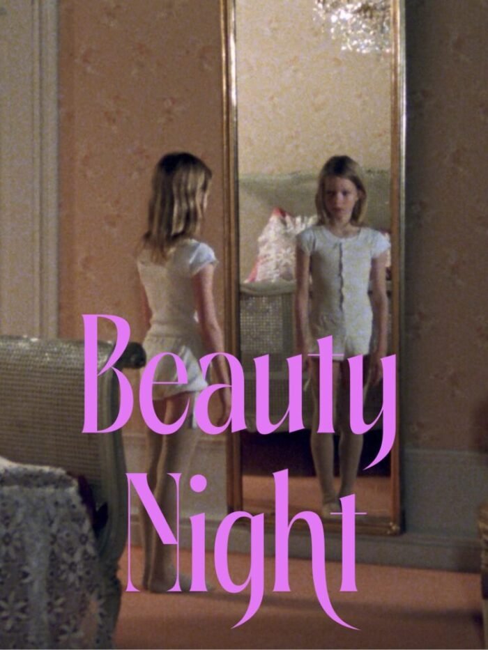 A Young girl looks at herself in a mirror behind the words BEAUTY NIGHT written on screen.