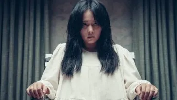 A woman in a white dress is tied to a chair in HOLY NIGHT: DEMON HUNTERS