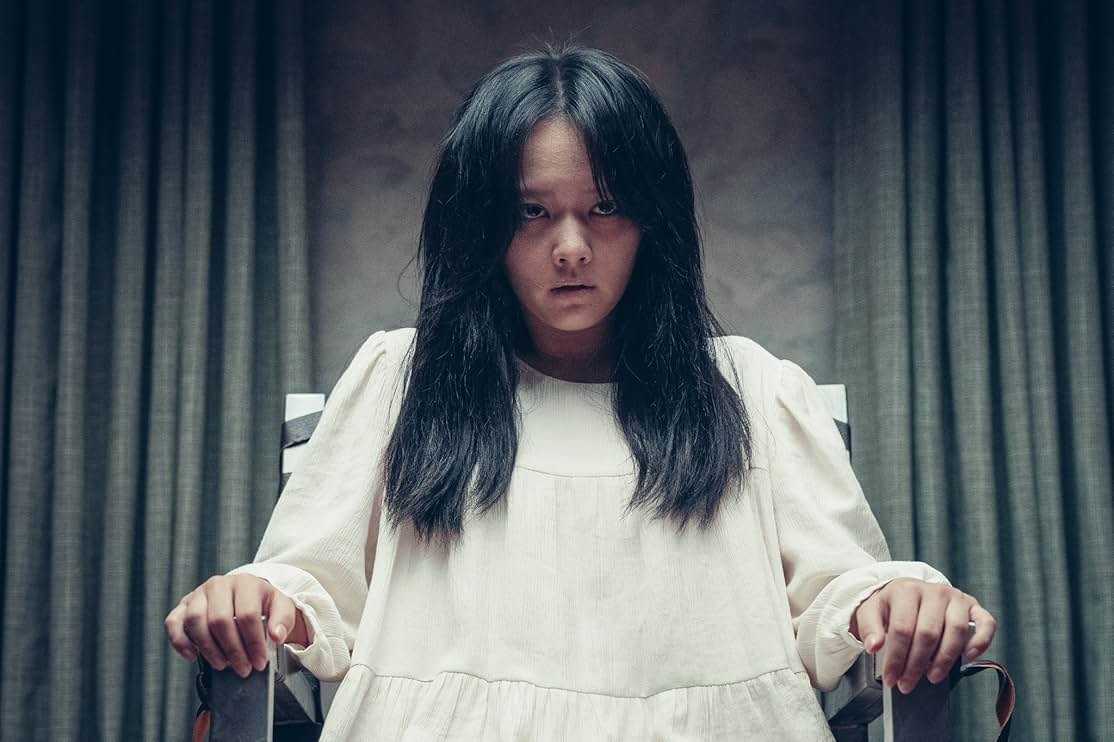 A woman in a white dress is tied to a chair in HOLY NIGHT: DEMON HUNTERS