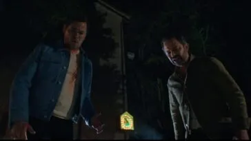 two men stand in the dark looking down toward the camera (I DON'T UNDERSTAND YOU)