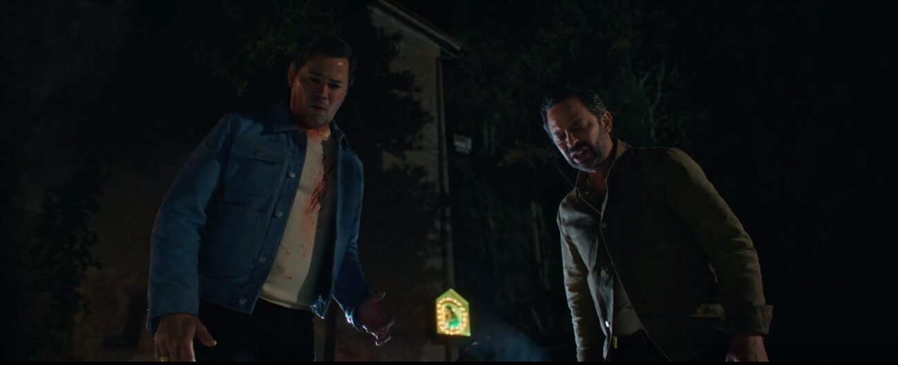 two men stand in the dark looking down toward the camera (I DON'T UNDERSTAND YOU)