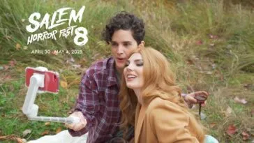 Two women take a loving photo together with a selfie stick during a picnic