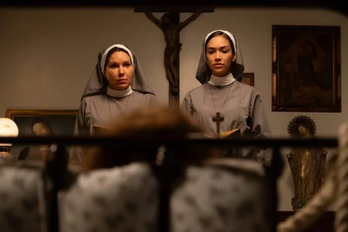 two nuns look into a closet.