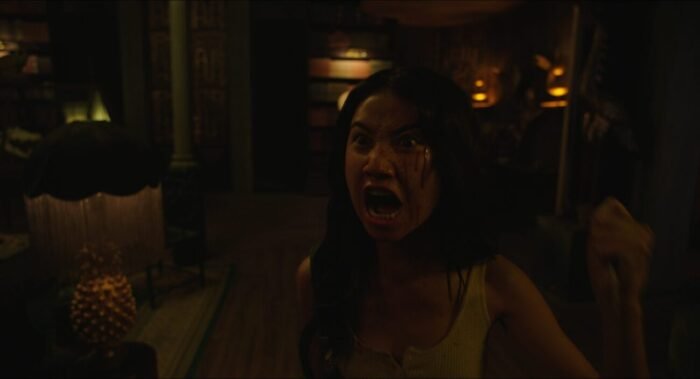 A woman screams while holding a knife in Daydreamers.