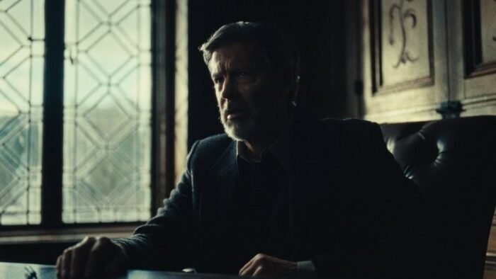 A man sitting at a desk in front of a window