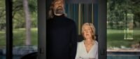A man standing next to a woman in the doorway of a glass slider. (House of Abraham)