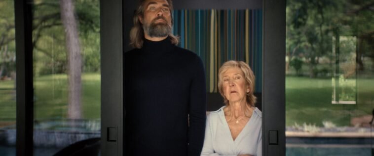 A man standing next to a woman in the doorway of a glass slider. (House of Abraham)