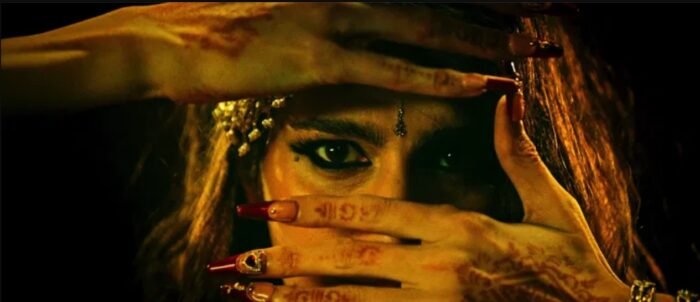 A woman's hand's frame her eyes