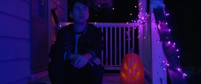 a man sits on a porch in the glow of a backlight in Black Theta (Soho Horror Pride 2025)