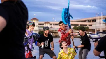 A group of rowdy people drop an over-sized battle axe on a man tied up on a pier in Hacked: A Double Entendre of Rage Fueled Karma