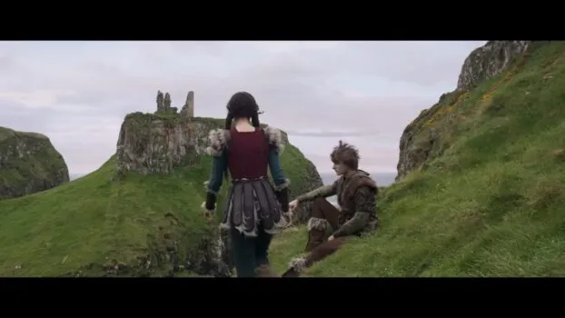 Astrid walks towards Hiccup, who is sitting on a cliff