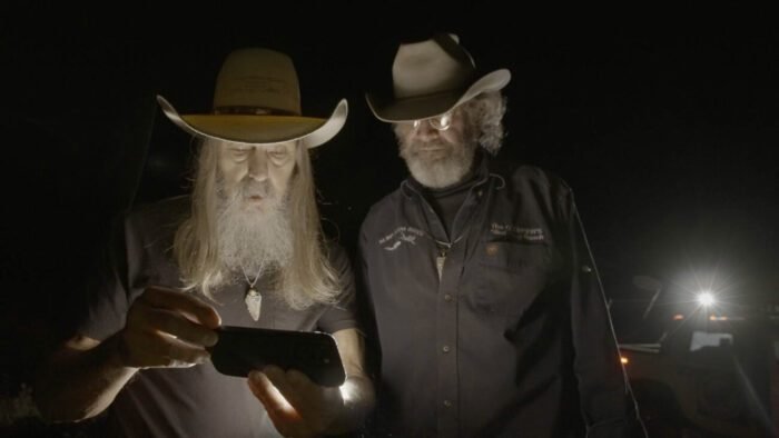 Charlie shows Duane the footage that security cameras picked up of trespasser. (Mystery at Blind Frog Ranch)