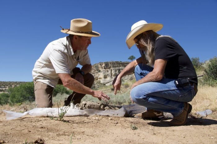 Eric and Charlie point to a core sample from the energy zone borehole (Mystery at Blind Frog Ranch)