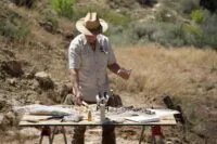 Geologist Eric Drummond analyzes a borehole sample with a gieger counter.