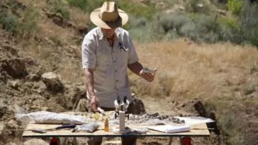 Geologist Eric Drummond analyzes a borehole sample with a gieger counter.