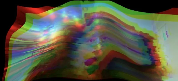 The image of someone's face is glitched out making for a colorful array of RGB pixelation.