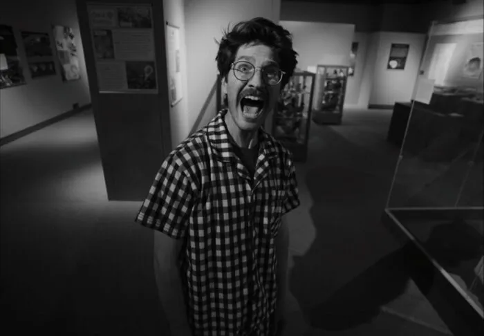 A black and white image of a man screaming