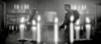A woman and a man are seen talking in a room with artifacts and lots of candles (WAVES OF MADNESS)
