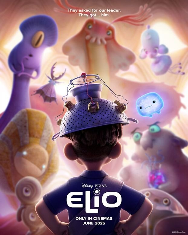 Elio with a makeshift helmet on, looking at a group of aliens