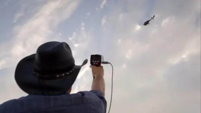 Thomas Winterton points the radar at Cameron Fugal's helicopter