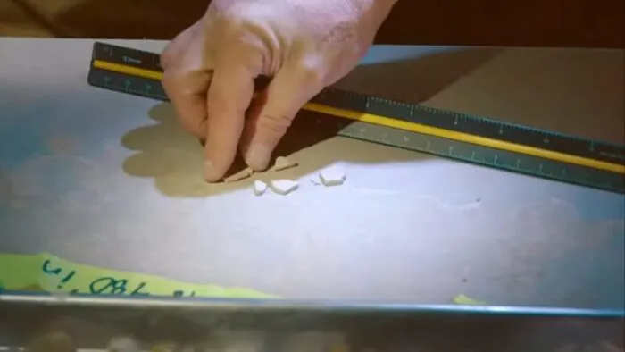 Dr. Travis Taylor examines a ceramic-like object from within the Mesa