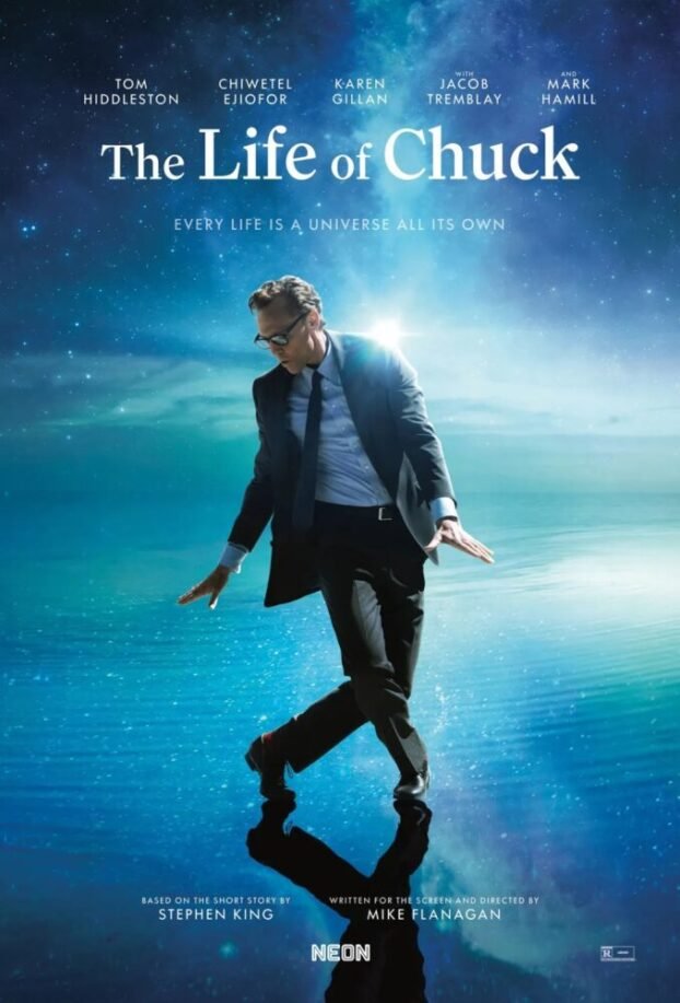 Chuck (Tom Hiddleston) dancing on top of blue waters and in front of a blue sky