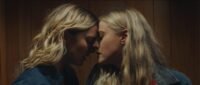 Two women rest their foreheads against one another in Abigail Before Beatrice