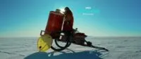 A young girl stands on a rickshaw next to a bright red barrel in the Bolivian desert (Cielo)