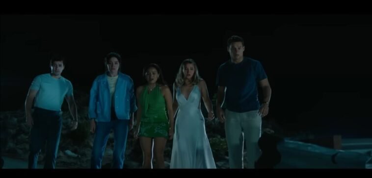 The five main friends, looking over the cliff at the wrecked car