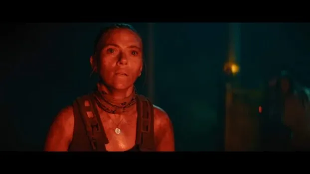 Zora in a red light, looking slightly dishelved