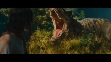 A woman faces a T-Rex roaring at her in the grass