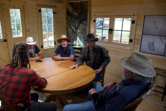 Chad Ollinger, Charlie Snider, Eric Drummond, Josh Feldman and Duane Ollinger discuss Eric's ore sample findings in the Hideout. (Blind Frog Ranch: Drain The Pond!)