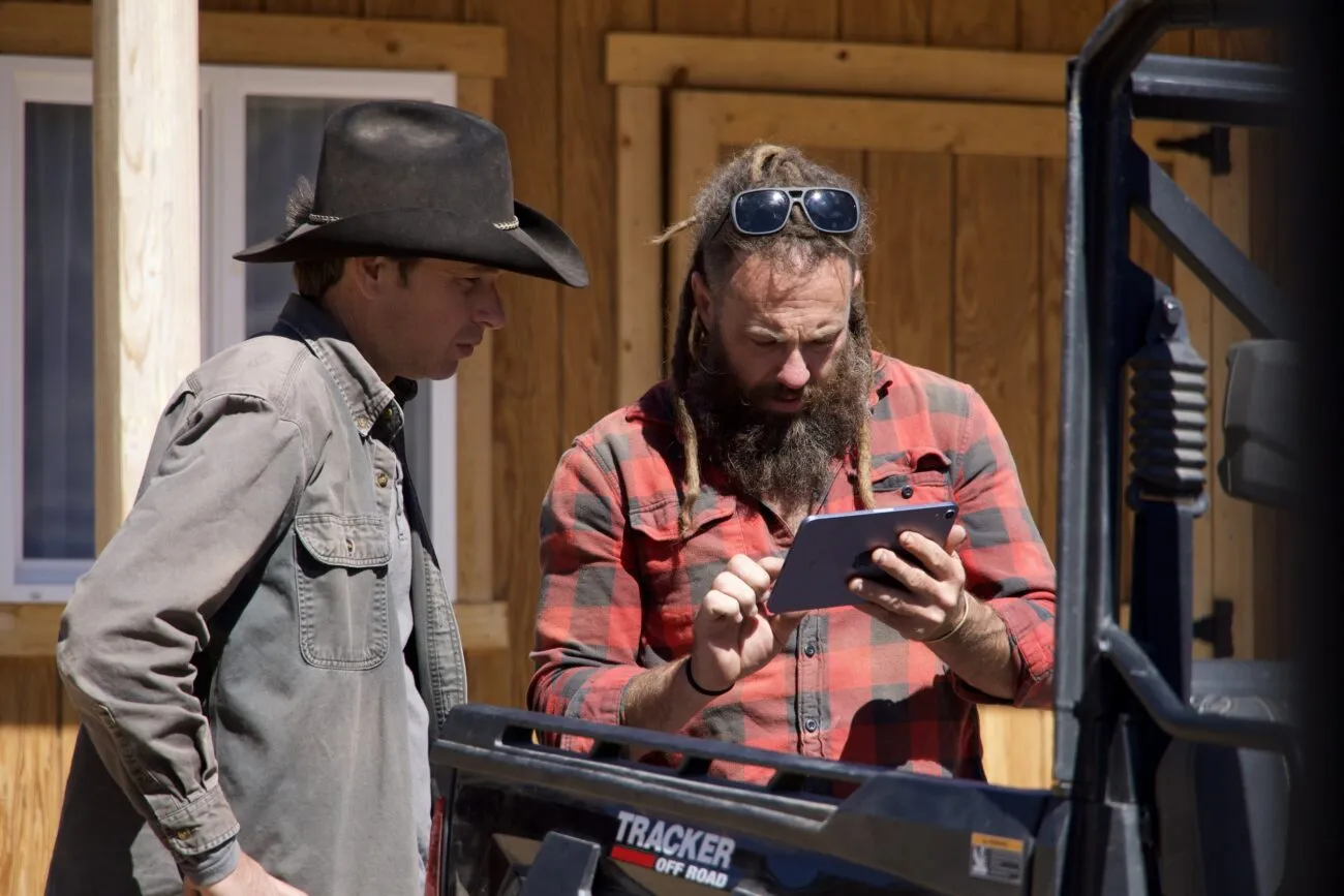 Outside of the Miner's Shack, Chad Ollinger loads surveillance footage of the intruder to show Josh Feldman.