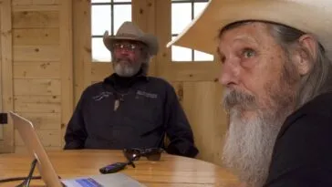 Duane Ollinger and Charlie Snider puzzle over security video of an unknown intruder to the ranch.